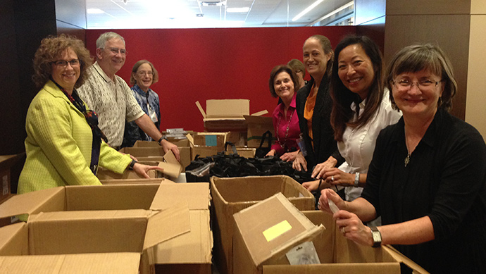 Group of people stuffing bags for the TEI conference