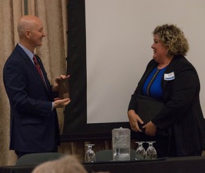 TEI Nebraska President Allyson Slobotski (right) presented Nebraska Gov. Pete Ricketts with a TEI plaque.