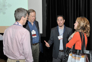 Conference participants chat with speakers Louis Mestier (left center, Hanger Inc.) and John Jung (right center, Govig & Associates) after the “Tax Talent in Transition: Planning Your Next Step and Shaping Your Career Options” session.