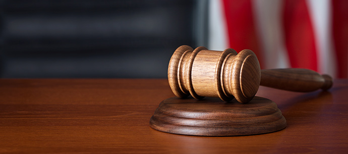 gavel on desk with american flag in the background