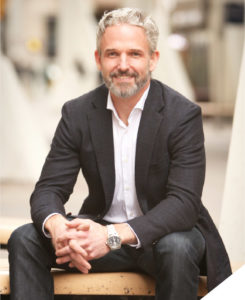 Portrait of Kurtis bond sitting on a bench outside